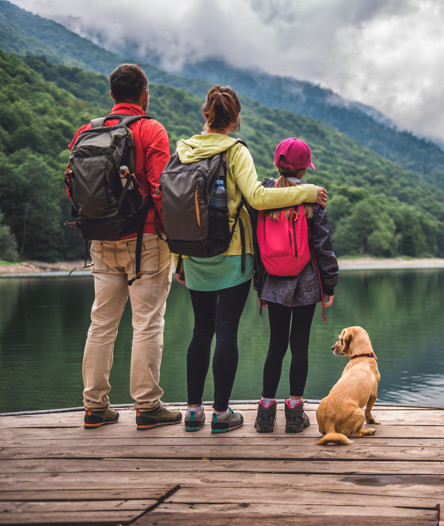 Family hiking by a lake in the mountains Family hiking by a lake in the mountains, enjoying nature and outdoor adventure.